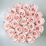 Pink ETERNAL roses in round flower box